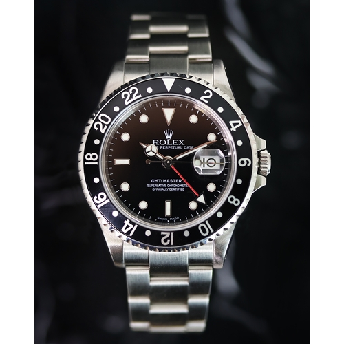 84 - ROLEX GMT MASTER II REFERENCE 16710 CIRCA 2001, circular gloss black dial with applied hour markers,... 