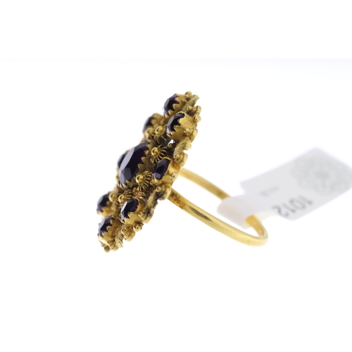 1007 - Antique Purple Stone Set Panel Ring, circular design with closed back settings, in yellow metal