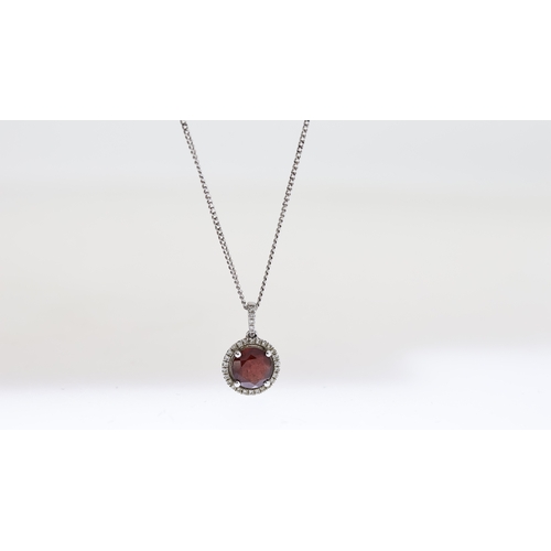 1025 - 9ct Garnet and diamond pendant with chain