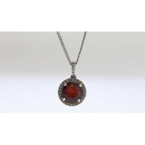 1025 - 9ct Garnet and diamond pendant with chain