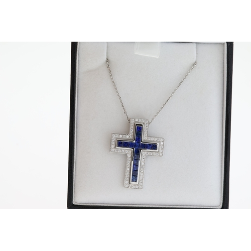 1059 - 18ct white gold two piece cross pendant set with square calibre-cut sapphires and RBC diamonds on a ... 