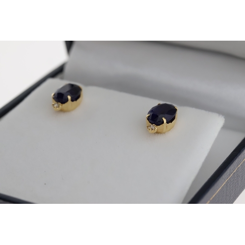 1060 - Pair of 18k yellow gold studs set with treated sapphires and diamonds, boxed. Oval sapphires 3.00ct.... 