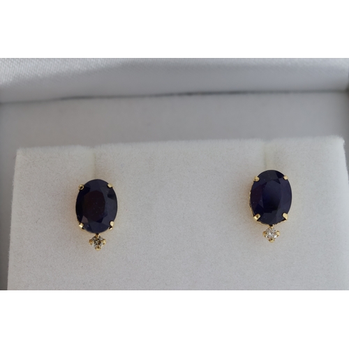 1060 - Pair of 18k yellow gold studs set with treated sapphires and diamonds, boxed. Oval sapphires 3.00ct.... 