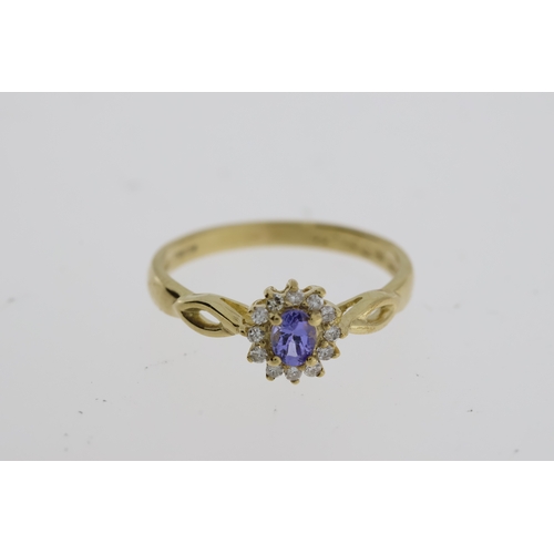 1062 - 9ct yellow gold tanzanite and diamond cluster dress ring. Oval-cut tanzanite 0.22ct approx. R/C diam... 