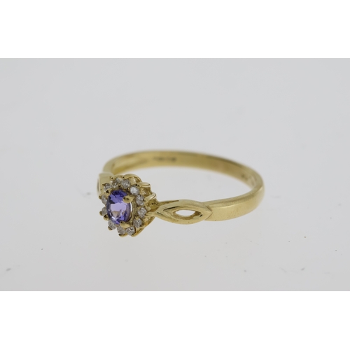 1062 - 9ct yellow gold tanzanite and diamond cluster dress ring. Oval-cut tanzanite 0.22ct approx. R/C diam... 