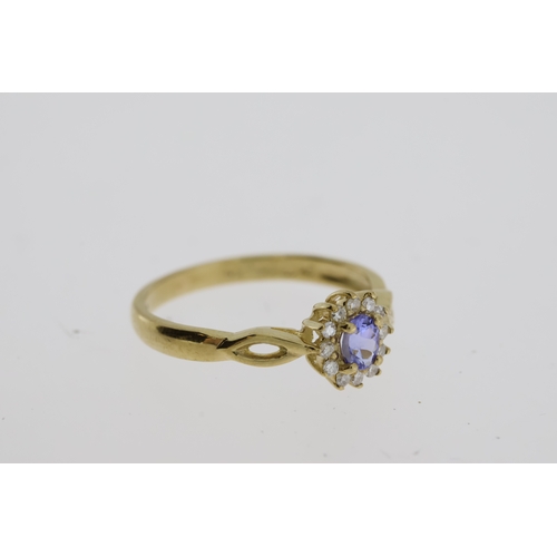 1062 - 9ct yellow gold tanzanite and diamond cluster dress ring. Oval-cut tanzanite 0.22ct approx. R/C diam... 