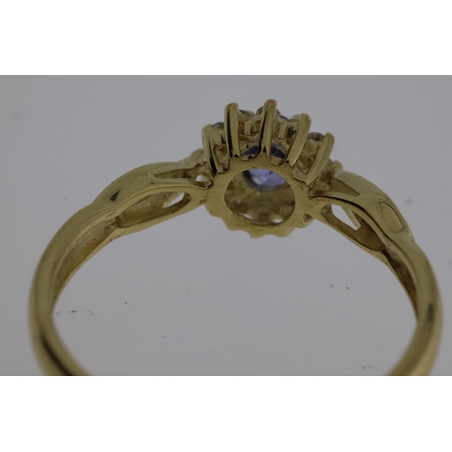 1062 - 9ct yellow gold tanzanite and diamond cluster dress ring. Oval-cut tanzanite 0.22ct approx. R/C diam... 