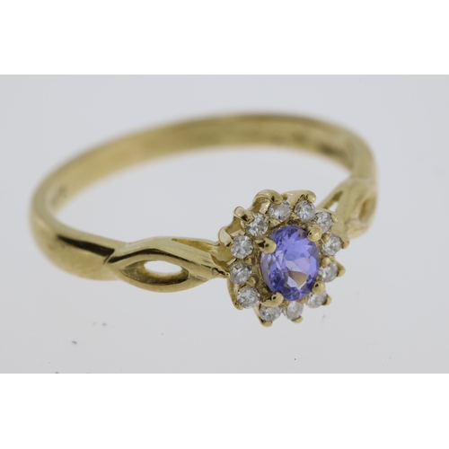 1062 - 9ct yellow gold tanzanite and diamond cluster dress ring. Oval-cut tanzanite 0.22ct approx. R/C diam... 