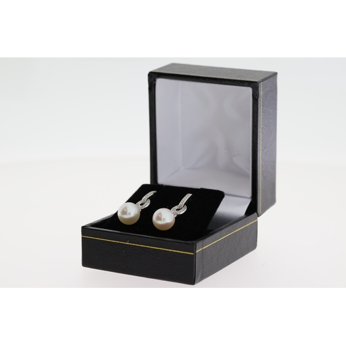 1063 - Pair of 9ct white gold diamond and pearl drop earrings, boxed. Diamonds 0.16ct