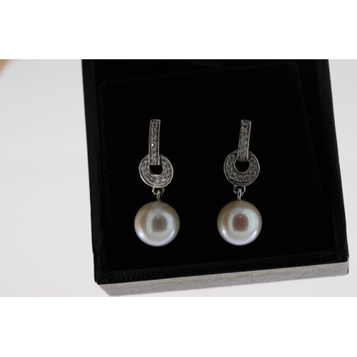 1063 - Pair of 9ct white gold diamond and pearl drop earrings, boxed. Diamonds 0.16ct