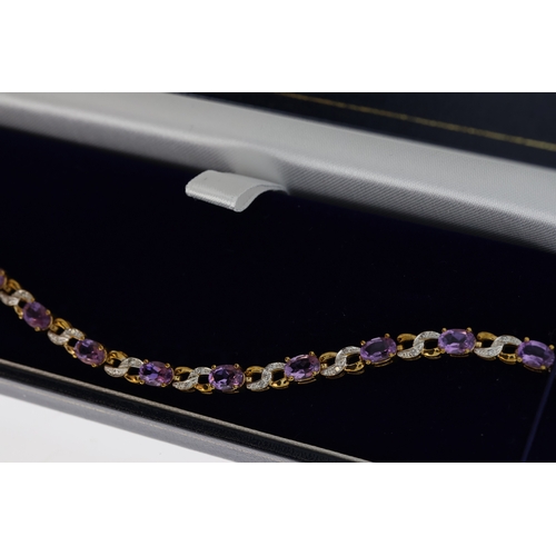 1076 - 9ct yellow gold amethyst and diamond figure-of-eight bracelet, boxed. Oval-cut amethysts 5.50ct appr... 