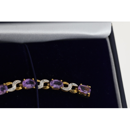 1076 - 9ct yellow gold amethyst and diamond figure-of-eight bracelet, boxed. Oval-cut amethysts 5.50ct appr... 