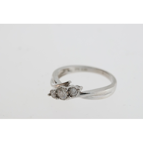 1079 - 9ct white gold graduated diamond trilogy ring in a twist mount. Diamonds 0.20ct