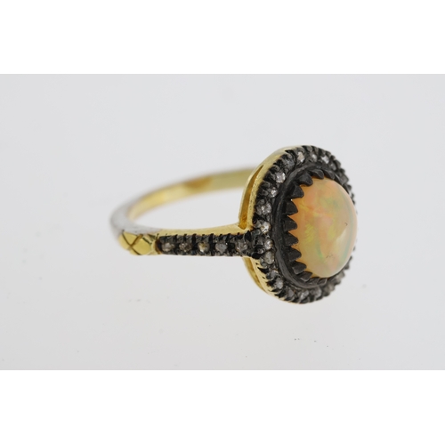 1080 - Silver-gilt opal and diamond halo ring with diamond shoulders. Opal 1.26ct. Rose-cut diamonds 0.33ct