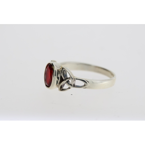 1086 - Silver celtic-style ring set with oval red CZ