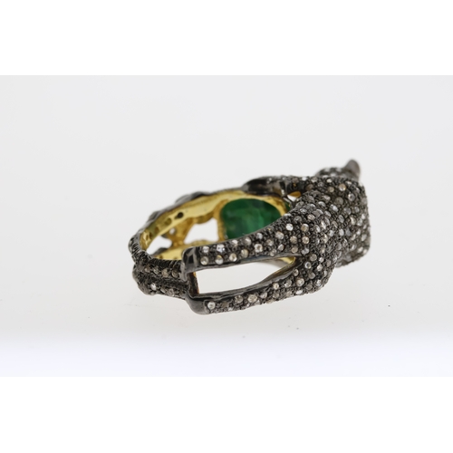 1087 - Unusual silver gilt panther ring heavily-set with diamonds. The panther is holding an oval emerald a... 