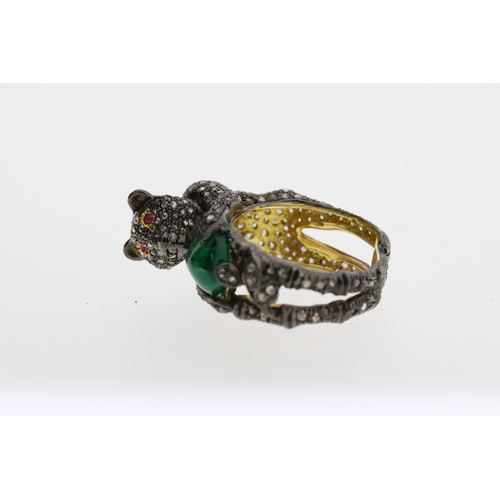 1087 - Unusual silver gilt panther ring heavily-set with diamonds. The panther is holding an oval emerald a... 