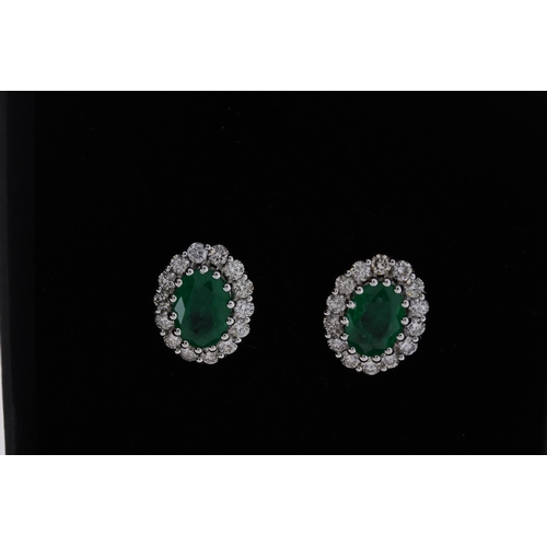 1092 - 18ct white gold oval emerald and RBC diamond cluster ear studs, boxed. Emeralds 1.42ct. Diamonds 0.6... 