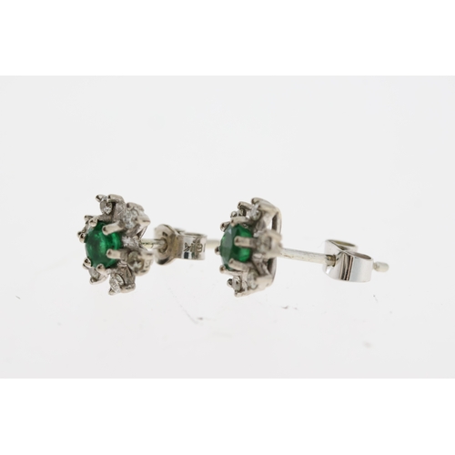 1102 - White metal green gemstone and diamond earrings. Diameter 0.8cm. Earring backs are marked 18