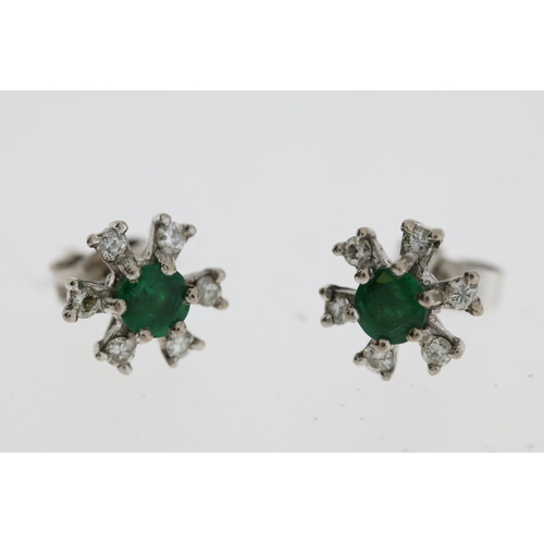 1102 - White metal green gemstone and diamond earrings. Diameter 0.8cm. Earring backs are marked 18