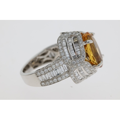 1104 - In 18 carat white gold an elaborate diamond setdress ring with an oval Brazilian Topaz in thecentre.... 