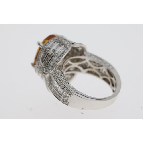 1104 - In 18 carat white gold an elaborate diamond setdress ring with an oval Brazilian Topaz in thecentre.... 