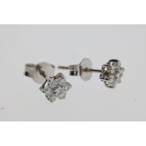 1106 - White gold diamond star earrings, set with 7round diamonds. Weight approx 0.15 carats