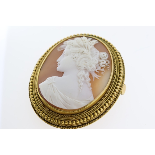 1110 - An antique shell cameo brooch depicting a ladyto her shoulder line set in a gold ornate frameapprox ... 