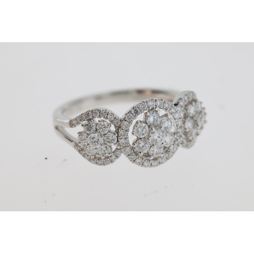 1117 - A pretty flower cluster diamond ring, 3 flowers
each set inside a halo of diamonds. Estimated to
be ... 