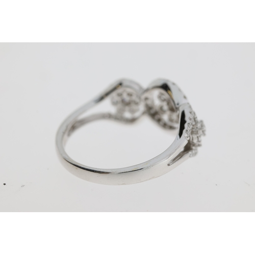 1117 - A pretty flower cluster diamond ring, 3 flowers
each set inside a halo of diamonds. Estimated to
be ... 