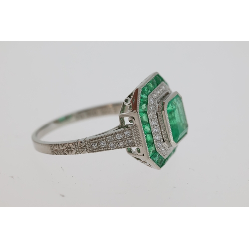 1119 - Columbian emerald and Damond set art deco
style target ring in platinum. Central emerald 0.7
x 0.7mm... 