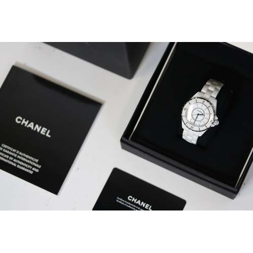 27 - CHANEL J12 QUARTZ WATCH W/BOX AND PAPERS 2006. Approx 34mm white ceramic case with a screw down case... 
