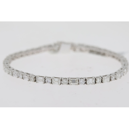 1009 - 18ct white gold round brilliant and baguette cut diamond line bracelet. Total diamond weight approx ... 