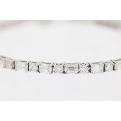 1009 - 18ct white gold round brilliant and baguette cut diamond line bracelet. Total diamond weight approx ... 