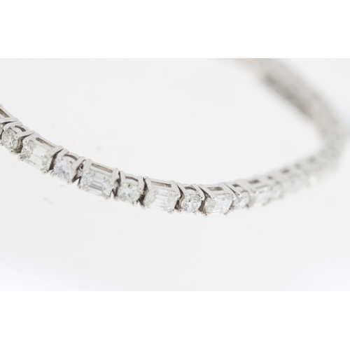 1009 - 18ct white gold round brilliant and baguette cut diamond line bracelet. Total diamond weight approx ... 