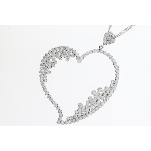 1011 - 18ct White gold Diamond set heart shaped pendant suspended from diamond set flower cluster on adjust... 