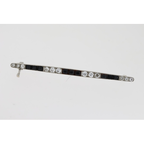 1012 - White metal, princess cut onyx and round brilliant cut diamond set bar brooch. tested as platinum