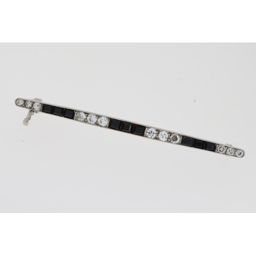 1012 - White metal, princess cut onyx and round brilliant cut diamond set bar brooch. tested as platinum