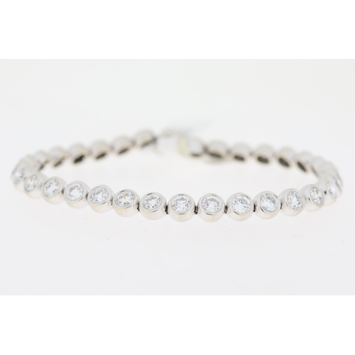 1014 - 8ct Diamond Line Bracelet, 18ct white gold rub over set round brilliant cut diamond line bracelet. T... 