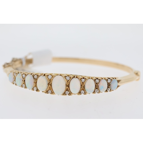 1019 - Period Opal and Diamond hinged bangle. 9 oval white opals in a graduated claw setting. 2 x diamonds ... 