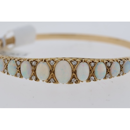 1019 - Period Opal and Diamond hinged bangle. 9 oval white opals in a graduated claw setting. 2 x diamonds ... 