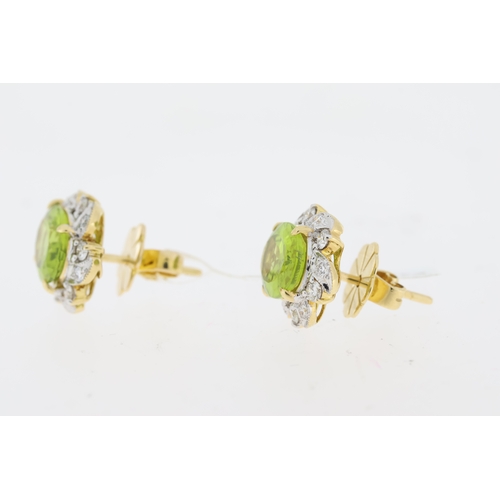 1021 - Oval cut peridot and round brilliant diamond halo earrings. Total peridot carat weight approximately... 