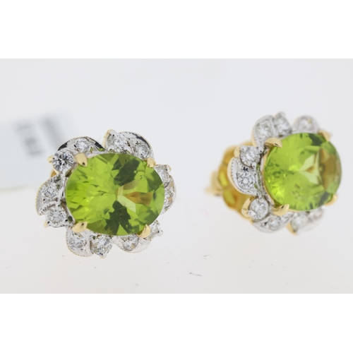 1021 - Oval cut peridot and round brilliant diamond halo earrings. Total peridot carat weight approximately... 