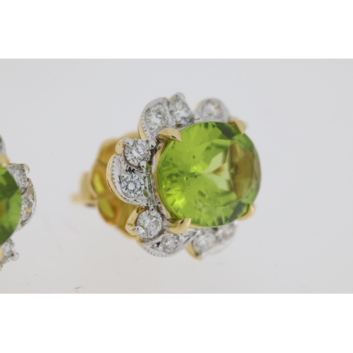 1021 - Oval cut peridot and round brilliant diamond halo earrings. Total peridot carat weight approximately... 