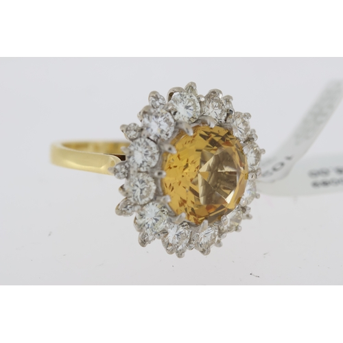 1029 - Imperial Topaz and diamond cluster ring. Faceted golden topaz surrounded by round brilliant cut diam... 