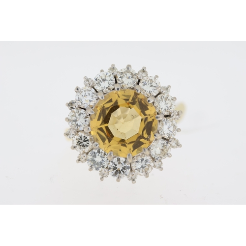 1029 - Imperial Topaz and diamond cluster ring. Faceted golden topaz surrounded by round brilliant cut diam... 