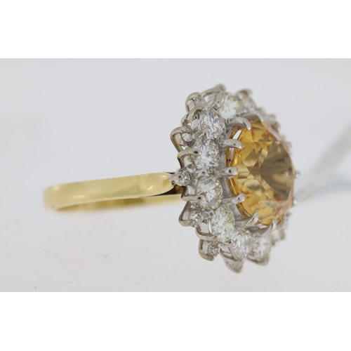 1029 - Imperial Topaz and diamond cluster ring. Faceted golden topaz surrounded by round brilliant cut diam... 