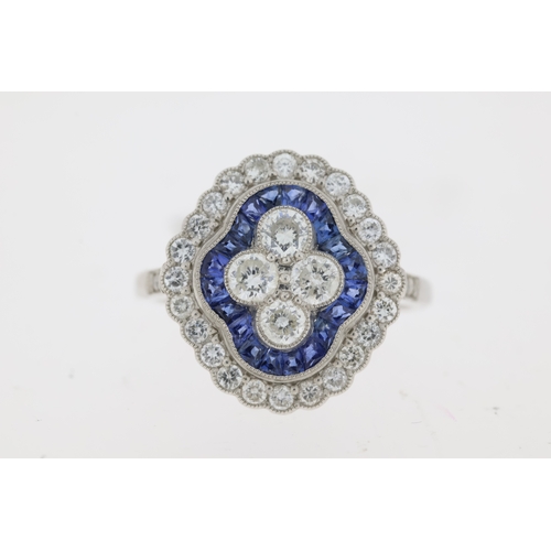 1030 - Platinum sapphire and diamond Edwardian style dress ring. 4 central round brilliant cut diamonds sur... 