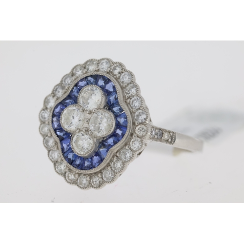 1030 - Platinum sapphire and diamond Edwardian style dress ring. 4 central round brilliant cut diamonds sur... 