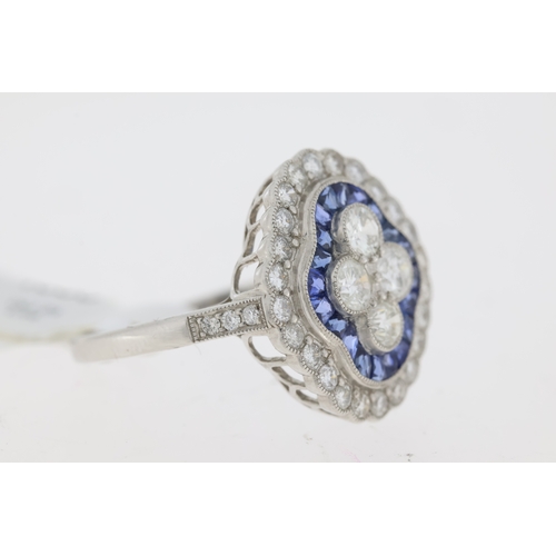 1030 - Platinum sapphire and diamond Edwardian style dress ring. 4 central round brilliant cut diamonds sur... 